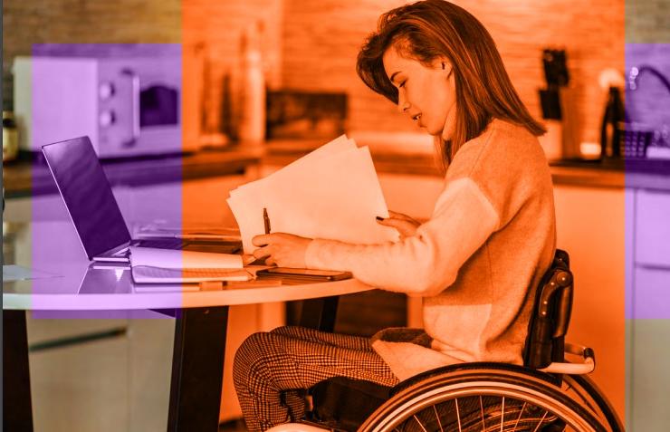 Women in a wheelchair working at home